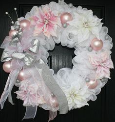 a wreath with pink and white flowers on it