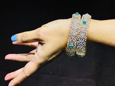 18 karat gold diamond kada for women with color stones - set of 2 (1pair)
  note : this item comes with a clip. so that you can open it and wear it directly on your wrist.
    note : minimum size : 2-5 & maximum size : 2-6.


enhance your wrist with the exquisite beauty of this 18 karat gold diamond kada for women with color stones - set of 2 (1pair) from totaram jewelers. made in india, this stunning piece of jewelry is designed to make you stand out in any crowd.    this diamon Diamond Fusion Bangle For Formal Occasions, Traditional Diamond Bangle With Diamond Accents, Fusion Style Diamond Hand Set Bangle, Gold Diamond Jewelry For Wedding And Festive Occasions, Formal Diamond Bangle With Stone Work, Diamond Bangle With Stone Work For Gift, Fusion Diamond Bangle Hand Set, Wedding Cubic Zirconia Bangle With Stone Work, Uncut Diamond Kada