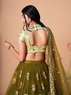 Wrapped up in the warmth of comfort and style, this pleasant olive green color lehenga is made with net material developed with mirror work, thread embroidery, and sequin work. This olive green lehenga arrives with a pastel green color art silk material choli formed with embroidery and mirror work. It also comes with an olive green color net material dupatta created with thread embroidery and sequin work. This olive green lehenga is stitched and can be customized up to 42 inches. The choli will Green Lehenga With Unstitched Blouse For Navratri, Fitted Green Choli With Pallu, Green Fitted Choli With Pallu, Designer Green Choli With Intricate Embroidery, Designer Green Lehenga With Unstitched Blouse, Fitted Green Choli With Zari Work, Fitted Embroidered Pista Green Lehenga, Fitted Pista Green Embroidered Lehenga, Fitted Embroidered Green Sharara