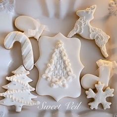 decorated cookies in the shape of christmas trees and snowflakes