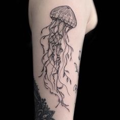 a black and white photo of a jellyfish tattoo