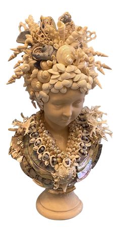 a sculpture of a woman's head covered in seashells and sea shells