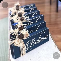 three wooden signs with burlocks tied to them on top of a wood table