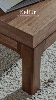 a close up of a coffee table on a carpeted floor with the words keltir above it