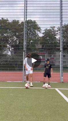 two people standing on a soccer field