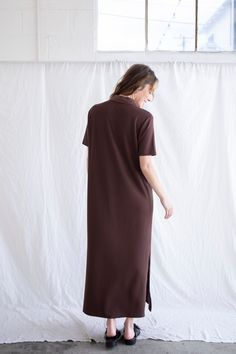 Vertical ribbed maxi dress with side slits and a button collar. - Sizing: Model is 5'8", wearing a size S - Content: 72% Polyester, 23% Rayon, 5% Spandex Care: Handwash recommended Imported Daywear Longline Maxi Dress, Maxi Dress With Side Slits For Loungewear, Midi Maxi Dress With Side Slits For Daywear, Midi Dress With Side Slits For Day Wear, Long Midi Dress With Side Slits For Daywear, Solid Maxi Dress With Side Slits And Split Hem, Brown Maxi Dress With Side Slits, Maxi Length Dress With Side Slits For Loungewear, Spring Ribbed Collared Dress