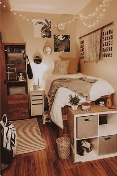 a bed room with a neatly made bed and lots of lights on the wall above it