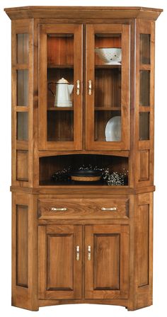 a wooden china cabinet with glass doors on the top and bottom shelves, in front of a white background