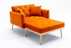 an orange chair and footstool with pillows on it's back, against a white background