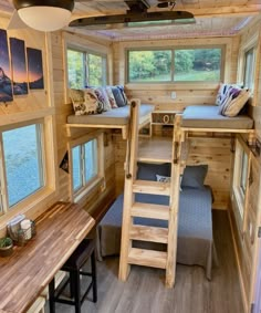 the interior of a tiny cabin with stairs leading up to two beds and a loft