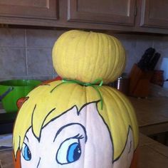 a pumpkin shaped like a cartoon character sitting on top of a counter