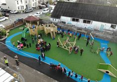 an overhead view of children's play area with playground equipment and people standing around