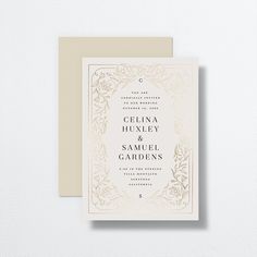 an elegant wedding card with gold foil on the front and back, featuring a floral border