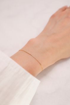 ITEM INFO Add a touch of refined elegance to your wrist with the 14K Solid Yellow Gold 0.5mm Box Chain Bracelet. This beautifully crafted bracelet features a sleek and durable 0.5mm box chain design, offering a subtle yet sophisticated shine. Crafted from premium 14K solid yellow gold, this bracelet is perfect for layering with other pieces or wearing alone for a minimalist, chic look. Its delicate design makes it a versatile accessory, ideal for both everyday wear and special occasions. Key Features: Material: Premium 14K solid yellow gold for a radiant and long-lasting finish Design: Sleek 0.5mm box chain, offering a delicate and refined appearance Style: Versatile and elegant, perfect for layering or wearing solo Quality: Expertly crafted for durability and long-lasting shine Comfort: L Classic Snake Chain Bracelet, Perfect As A Gift, Classic Snake Chain Bracelet Gift, Classic Snake Chain Bracelet For Gift, Classic Snake Chain Bracelet, Minimalist Box Chain Bracelet As Gift, Minimalist Box Chain Bracelet Gift, Minimalist Flexible Chain Bracelet, Minimalist Hypoallergenic Chain Bracelet For Formal Occasions, Formal Minimalist Hypoallergenic Chain Bracelet