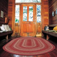 a room with wood paneling and two benches in front of a wooden door that leads to the outside