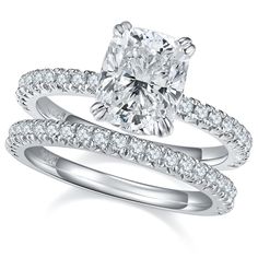 a cushion cut diamond engagement ring set with matching band and wedding band in 18k white gold