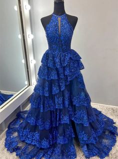 Knockout looks are guaranteed with this dazzling royal blue prom dress that epitomizes both modern glamor and timeless sophistication. The dress features an array of sparkling sequins and detailed floral motifs, creating a visually striking effect. A unique high neckline with a delicate keyhole offers a glimpse of allure, leading down to a fitted bodice that defines every curve. The tiered, ruffled skirt not only adds dramatic flair but also swings charmingly with each step, highlighted by a tasteful front slit that promises ease of movement. This gown is designed for those who wish to own the spotlight, ensuring a memorable impression at any prom or gala event. Corset Prom Dress, Tulle Material, Blue Corset, Ruffle Gown, Dress With Split, Mismatched Bridesmaid Dresses, Wedding Dresses With Flowers, Corset Dress Prom, Wedding Flower Girl Dresses