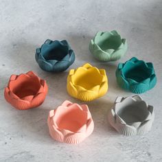 six different colored muffin cups sitting next to each other