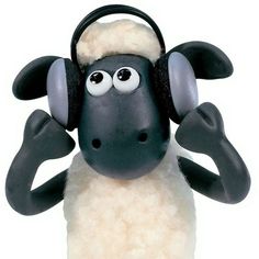 a black and white sheep with headphones on its ears