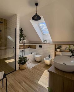 a bathroom with two sinks and a skylight in the ceiling, along with a bathtub