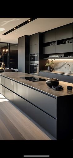 a modern kitchen with black cabinets and white counter tops is featured in this image from the website