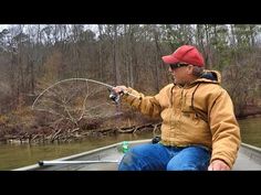 a man sitting in a boat holding a fishing rod