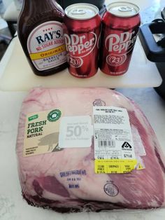 ham wrapped in plastic and packaged with ray's cold cuts on the counter next to two sodas