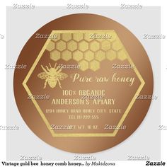 a gold honey label with the words, pure raw honey and an image of a bee on