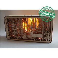 a metal box with a deer in the woods on it's side and lights inside