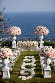 an image of a wedding ceremony with flowers on the aisle