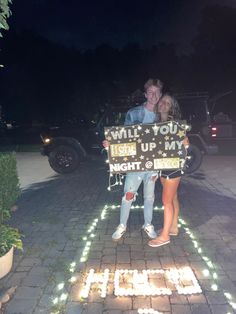 a man and woman standing next to each other holding a sign that says i will you step up my height?