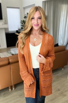 Look luxurious and feel your best while sporting this beautiful burnt orange Groove With Me Cardigan. Crafted with a loose knit, open front, and longline design - this cardigan will keep you cozy without compromising style. The knit border detail and warm color will make you feel glamorous and inspire confidence! Loose Sweater Knit Open Front Knit Border Detail Longline Silhouette 100% Acrylic True to Size S: Chest 38" Length 31"M: Chest 38" Length 32"L: Chest 38" Length 32"1XL: Chest 42" Length Orange Cardigan Outfit, Knit Border, 60 Outfits, Orange Cardigan, Cap Sleeve Top, Cardigan Outfits, Loose Knit, Graphic Tops, Loose Sweater