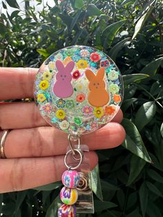 This bold and bright badge reel cutie is showing off those little peep Easter bunnies in such a bold way!  These make super fun and useful gifts for any person in any profession. A great gift choice for nurses, medical staff, office staff, and anyone who is required to wear a badge. Hand made with glitter, resin, and design printed to make it waterproof. Each design is handmade so each badge we make will look slightly different than the next.  Indoor and outdoor photos to show details.  TERMS AN Cute Personalized Badge Reel For Gifts, Personalized Cute Badge Reel For Gift, Fun Pink Badge Holders For Gift, Playful Multicolor Badge Reel For Gifts, Playful Multicolor Badge Reel As Gift, Fun Pink Badge Reel For Gift, Personalized Fun Badge Reel For Gift, Personalized Fun Badge Reel Gift, Novelty Multicolor Badge Reel For Hobby