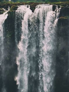 an aerial view of a large waterfall with water cascading down it's sides