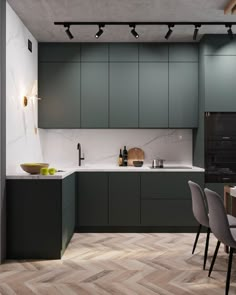 a modern kitchen with green cabinets and marble counter tops