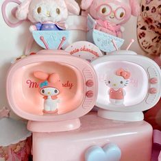 hello kitty dishes are stacked on top of each other in front of stuffed animals and teddy bears