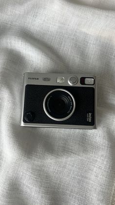 a camera sitting on top of a white sheet