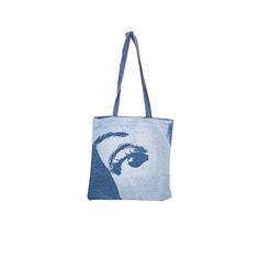 a tote bag with an image of a woman's face on it,