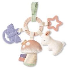 an assortment of toys including a stuffed animal, rattler and teethpick on a white background