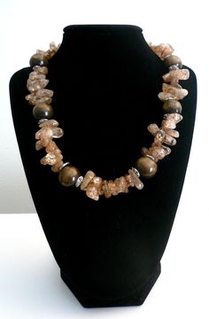 "Earthy Mocha & Chocolate Rutilated Quartz Wood Necklace. Wood Fall Necklace, Neutral Necklace. Fall 2018 Jewelry Trends This is a beautiful Mocha and Chocolate Rutilated quartz and wood necklace. Soft Earth Tones can be worn very frequently with many styles. Neutral so goes perfectly with many colors Perfect for Fall Silver Tone Toggle Closure. Approx 17 inches long *If you have have any questions regarding this item, please hit the \"Ask a Question\" button next to the price and I will get Brown Stone Necklaces For Gifts, Brown Gemstone Beads Necklace For Gift, Brown Stone Necklace For Gift, Brown Gemstone Beads Crystal Necklace For Gifts, Brown Necklaces With Stones For Gifts, Spiritual Brown Stone Necklace, Soft Earth Tones, Fall Necklace, Mocha Chocolate