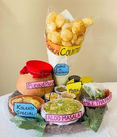 a basket filled with different types of food on top of a white tablecloth covered table