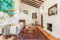 a living room filled with furniture and a fire place next to a painting on the wall