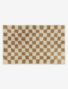 a brown and white checkered rug on a white surface with no one in it