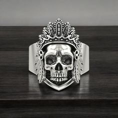 Celebrate the rich cultural heritage and powerful symbolism with our Indian Skull Ring, crafted from high-quality 925 Sterling Silver. This striking ring features an intricately detailed Indian skull design, representing strength, resilience, and ancestral heritage. Each piece is meticulously handmade, showcasing exceptional craftsmanship and attention to detail, ensuring every ring is unique and of the highest quality. Perfect for both men and women, this statement ring adds a touch of cultural Silver Oxidized Skull Ring, Symbolic Ceremonial White Gold Jewelry, Symbolic Engraved White Gold Skull Ring, Silver Symbolic Skull Ring, Silver Symbolic Skull Ring Hallmarked, Symbolic Silver Skull Ring, Spiritual Silver Engraved Skull Ring, Ceremonial Hallmarked Jewelry, Women Symbol