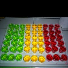 an assortment of colored cups sitting on top of a counter