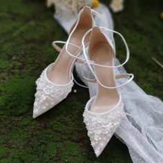 the bride's wedding shoes are sitting on the grass