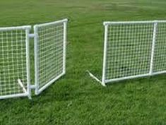 two white soccer goal posts sitting in the grass