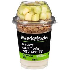 a plastic container filled with yogurt and chopped apples