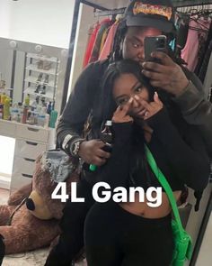 a man taking a selfie with a woman in front of him and the words 4l gang above it