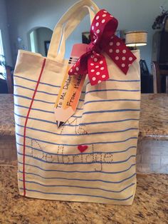 a white bag with red polka dots and a ribbon on the handle that says happy valentine's day